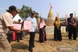 Bupati Kediri Hanindhito Himawan Pramana (kedua kiri) memberikan Nomor Induk Berusaha (NIB) kepada sejumlah perajin tahu saat Festival Tahu di sentra perajin tahu Desa Sendang, Kediri, Jawa Timur, Selasa (22/8/2023). Festival Tahu yang menyediakan gunungan berisi 20 ribu potong tahu gratis tersebut sebagai upaya pemerintah daerah setempat mempromosikan Desa Sedang sebagai Kampung Tahu sekaligus memberikan pendampingan melalui penerbitan NIB kepada 57 orang produsen tahu. ANTARA Jatim/Prasetia Fauzani/zk