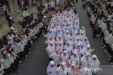 Foto udara peserta mengikuti kirab kebangsaan merah putih di Kota Tasikmalaya, Jawa Barat, Jumat (25/8/2023). Kirab merah putih yang diikuti dari masyarakat, tokoh lintas agama, TNI dan Polri se-Priangan Timur itu, bertujuan untuk menjaga persatuan NKRI dan menumbuhkan nasionalisme dan sikap toleransi antarberagama. ANTARA FOTO/Adeng Bustomi/agr