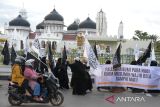 Masyarakat yang tergabung dalam Forum Ukhuwah Muslimin dan Muslimah peduli Palestina  membawa spanduk melakukan longmarch  saat aksi damai di kawasan Masjid Raya Baiturrahman, Banda Aceh, Aceh, Jumat (13/10/2023). Forum Ukhuwah Muslimn dan Muslimat  mengutuk serangan zionis Israel terhadap Palestina dan mendesak  negara negara Arab dan PBB  berperan dalam mewujudkan situasi kondusif di Palestina. ANTARA FOTO/Ampelsa.