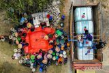 foto udara sejumlah warga mengisi air bersih ke dalam jeriken saat pendistribusian bantuan air bersih oleh BPBD di Bojonegoro, Jawa Timur, Kamis (26/10/2023). BPBD Bojonegoro telah menyalurkan sedikitnya 13 juta liter air bersih ke 109 desa yang terdampak kekeringan sejak Juli 2023. ANTARA Jatim/Muhammad Mada/zk