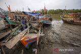 Nelayan berada di atas kapalnya yang bersandar di muara Karangsong, Indramayu, Jawa Barat, Senin (27/11/2023). Menurut nelayan setempat, sejak sebulan terakhir pendangkalan terjadi di muara sungai yang berada di kawasan Pelabuhan Pendaratan Ikan Karangsong tersebut mengakibatkan ratusan kapal kesulitan untuk keluar masuk pelabuhan. ANTARA FOTO/Dedhez Anggara/agr