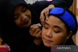 Penyandang disabilitas dirias wajahnya oleh penata rias dari West Borneo Makeup Artist (WBM) Community saat pelatihan tata cara make-up profesional di rumah jabatan Wali Kota Pontianak, Kalimantan Barat, Selasa (19/12/2023). Kegiatan yang diselenggarakan oleh TP PKK Kota Pontianak bersama WBM Community tersebut guna meningkatkan rasa percaya diri serta memberikan keterampilan make-up profesional untuk penyandang disabilitas agar dapat berwirausaha. ANTARA FOTO/Jessica Wuysang