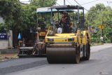 Pekerja melakukan pengaspala pada proyek pelebaran jalan di Banyakan, Kediri, Jawa Timur, Selasa (9/1/2024). Sejumlah jalan menuju kawasan proyek pembangunan bandara Kediri diperlebar yakni jalan daerah Gringging sepanjang 10 kilometer dan sejumlah ruas jalan di Kecamatan Banyakan sebagai upaya pemerintah memberikan daya dukung dari hadirnya Bandara Internasional Dhoho Kediri yang murni dibiayai oleh swasta. Antara Jatim/Prasetia Fauzani.