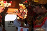 Anggota Kelompok Penyelenggara Pemungutan Suara (KPPS) yang berbusana kesenian Arja atau opera khas Bali mempersiapkan kotak suara dan surat suara pada Pemilu 2024 di TPS 20 Banjar Blungbang, Desa Penarungan, Badung, Bali, Rabu (14/2/2024). Anggota KPPS sengaja mengenakan busana tersebut yang mengusung tema Calonarang Cupak Gerantang sebagai upaya kreatif untuk meningkatkan partisipasi pemilih pada Pemilu 2024. ANTARA FOTO/Nyoman Hendra Wibowo/wsj.