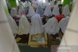 Jemaah perempuan berzikir dan membaca doa saat mengikuti ibadah  suluk di Dayah Darul Aman, Desa Lampuuk, Kabupaten Aceh Besar, Aceh, Rabu  (13/3/2024). Aktivitas spritual suluk pada bulan Ramadhan 1445 Hijriyah diikuti jamaah laki laki dan perempuan di pesatren tersebut memperbanyak dzikir, shalat sunah, dan ibadah lainnya yang bertujuan membersihkan hati dan menyucikan jiwa serta mendekatkan diri kepada Allah SWT.  ANTARA FOTO/Ampelsa.