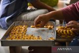 Pekerja menyelesaikan pembuatan kue kering di industri rumahan Ika Cokies, Medan, Sumatera Utara, Rabu (3/4/2024). Menurut pemilik usaha, menjelang Lebaran permintaan kue kering yang dijual dengan harga Rp45.000  hingga Rp75.000 per stoples tersebut meningkat sekitar 60 persen dibanding tahun kemarin. ANTARA FOTO/Fransisco Carolio