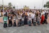 Ketua Muslimat Nahdlatul Ulama Khofifah Indar Parawansa (tengah) berfoto bersama saat memberikan santunan kepada anak yatim di Tuban, Jawa Timur, Jumat (5/4/2024). Pemerintah setempat berkolaborasi dengan Badan Amil Zakat Nasional (BAZNAS) memberikan santunan kepada 2000 anak yatim di wilayah tersebut untuk menyemarakan bulan Ramadhan dan memperingati Nuzulul Qur'an.  Antara Jatim/Muhammad Mada/um