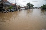Sejumlah kendaraan bermotor terjebak antrean akibat banjir yang menggenangi kawasan Jalan Raya Pantura Kraton, Pasuruan, Jawa Timur, Selasa (9/4/2024). Banjir yang diakibatkan curah hujan tinggi sejak Senin (8/4) malam dan meluapnya Sungai Welang tersebut mengakibatkan jalan raya Pantura terendam air setinggi 60 cm. Antara Jatim/Umarul Faruq/mas 
