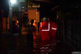 Sejumlah petugas Badan Penanggulanan Bencana Daerah (BPBD) memantau kondisi air saat terjadi banjir di Manguharjo, Kota Madiun, Jawa Timur, Selasa (23/4/2024). Sebanyak 38 rumah warga yang dihuni sekitar 150 jiwa di wilayah tersebut terendam banjir akibat hujan deras sehingga sungai meluap. Antara Jatim/Siswowidodo/mas.