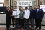 Wali Kota Surabaya Eri Cahyadi (ketiga kiri) didampingi Wakil Wali Kota Armuji (ketiga kanani) menerima piagam penghargaan rekor MURI dari Direktur Operasional Rekor MURI Jusuf Ngadri (kiri) saat Resepsi Hari Jadi ke-731 Kota Surabaya di Balai Kota Surabaya, Jawa Timur, Jumat (31/5/2024). Penganugerahan rekor MURI tersebut diberikan kepada Pemerintah Kota Surabaya atas pembentukan secara serentak pos bantuan hukum terbanyak yaitu 1.368 di Rukun Warga (RW) se-Kota Surabaya guna memberikan edukasi dan pendampingan hukum bagi masyarakat. Antara Jatim/Moch Asim/um.