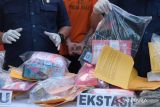 Polisi menata barang bukti saat konferensi pers hasil pengungkapan kasus dalam Operasi Antik Agung 2024 di Polda Bali, Denpasar, Bali, Kamis (20/6/2024). Operasi yang digelar pada 31 Mei hingga 15 Juni 2024 tersebut, polisi berhasil mengungkap 147 kasus dengan menyita 4,2 kg ganja, 2,1 kg sabu-sabu, 3,2 kg MDMA, 1.253 butir ekstasi, 255 butir pil koplo dan 1.760 botol serta 6 jerigen minuman beralkohol jenis arak. ANTARA FOTO/Nyoman Hendra Wibowo/wsj.