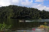 Sejumlah pengunjung menikmati keindahan Danau Law Kawar di Desa Kutagugung, Kecamatan Naman Teran, Kabupaten Karo, Sumatera Utara, Sabtu (6/7/2024). Wisata Danau Law Kawar yang memiliki luas 200 hektare tersebut merupakan wisata legenda yang menceritakan sebuah desa yang tenggelam akibat kutukan seorang nenek yang merasa sakit hati kepada anak dan cucu yang telah memberikan makan sisa dari acara adat masyarakat Karo. ANTARA FOTO/Yudi Manar