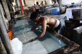 Pekerja membuat tahu di industri rumahan Dusun Bapang, Desa Sumbermulyo, Kecamatan Jogoroto, Kabupaten Jombang, Jawa Timur, Sabtu (20/7/2024). Menurut pengusaha, produksi tahu yang sudah digeluti sejak tahun 2012 lalu itu bisa memproduksi 1,5 ton tahu mentah serta 500 kuintal tahu goreng dalam sehari dengan pangsa pasar ke wilayah Gresik dan Surabaya. Antara Jatim/Syaiful Arif/um