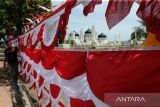 Pedagang musiman menata sejumlah bendera dan pernak-pernik HUT ke-79 Kemerdekaan RI di kawasan Masjid Raya Baiturrahman, Banda Aceh, Aceh, Kamis (1/8/2024). Menjelang perayaan HUT ke-79 Kemerdekaan  RI, penjualan pernak pernik dan bendera merah putih yang didatangkan dari luar proivinsi Aceh mulai ramai dengan harga penawaran mulai dari Rp15.000 hingga Rp450.000 per lembar menurut ukurannya. ANTARA FOTO/Ampelsa.