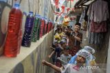 Seniman dari kelompok teater Bon Puppet berjalan bersama anak-anak saat menampilkan teatrikal boneka bertajuk Taman Dorong di Braga, Bandung, Jawa Barat, Sabtu (10/8/2024). Teater tersebut ditampilkan dengan merespon ruang publik dan berkeliling dalam permukiman bersama anak-anak di Kawasan Braga agar tetap bisa berimajinasi, bertualang, bermain hingga peduli akan kondisi lingkungan perkampungan yang menjadi tempat tinggal dan berkehidupan. ANTARA FOTO/Novrian Arbi/agr