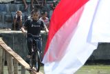 Peserta mengikuti lomba ketangkasan bersepeda di sungai di Jogoloyo, Surabaya, Jawa Timur, Minggu (11/8/2024). Lomba ketangkasan dengan mengayuh sepeda meniti papan kayu di atas sungai itu untuk menyemarakkan HUT ke-79 Republik Indonesia. ANTARA Jatim/Didik Suhartono/mas.