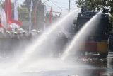 Mobil water canon Brimob Polda Jatim menyemprotkan air untuk membubarkan massa saat Simulasi Sistem Pengamanan Kota (Sispamkota) di Kota Kediri, Jawa Timur, Kamis (15/8/2024). Simulasi yang diikuti oleh personil Polri dan TNI tersebut sebagai upaya kesiapan dalam mengamankan tahapan Pemilihan Kepala Daerah (Pilkada) 2024. ANTARA Jatim/Prasetia Fauzani/mas.