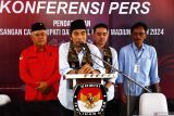 Bakal Calon Bupati Madiun Ahmad Dawami Ragil Saputro (kedua kiri) didampingi Bakal Calon Wakil Bupati Sandhika Ratna Ferryantiko (kedua kanan) dan pengurus parpol pengusul menjawab wartawan seusai mendaftarkan diri sebagai pasangan bakal calon peserta Pilkada di KPU Kabupaten Madiun, Jawa Timur, Rabu (28/8/2024). Pasangan Ahmad Dawami Ragil Saputro-Sandhika Ratna Ferryantiko mendaftarkan diri sebagai bakal calon Bupati Madiun yang diusung Partai Demokrat dan PDIP. Antara Jatim/Siswowidodo/um 