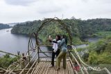 Pengunjung berswafoto pemandangan bendungan Leuwikeris yang dikelola Pokdarwis di Karang Hantu, Kabupaten Ciamis, Jawa Barat, Senin (2/9/2024). Sejak diresmikannya bendungan Leuwikeris destinasi wisata baru dikawasan tersebut banyak bermunculan dan membantu ekonomi masyarakat sekitar serta membuka lapangan kerja baru. ANTARA FOTO/Adeng Bustomi/agr
