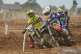 Pembalap motor Banten Jepri Bule (kiri) dan pembalap Papua Barat Dimas Lintang Trenggono (kanan) beradu cepat pada final balap motor grasstrack modifikasi perorangan PON XXI Aceh-Sumut 2024 di Sirkuit GTX Sena Kualanamu Sumut, Deli Serdang, Sumatera Utara, Senin (16/9/2024). Pembalap Jawa Barat Prima Julio Sudrajat berhasil meraih medali emas dengan catatan 13 menit 52 detik, disusul pembalap Aceh Lanthian meraih medali perak dengan catatan waktu 13 menit 56 detik dan pembalap Banten Jepri Bule meraih medali perunggu dengan catatan waktu 14 menit 15 detik. ANTARA FOTO/Makna Zaezar/rwa/gp