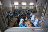 Siswa menyantap makanan bergizi gratis saat kegiatan mitigasi operasional dan uji coba makan bergizi gratis (MBG) di SMPN 1 Cirebon, Kota Cirebon, Jawa Barat, Rabu (25/9/2024). Uji coba makan bergizi gratis tersebut bertujuan untuk memberi edukasi siswa tentang pentingnya pemenuhan gizi seimbang bagi tumbuh kembang dan upaya mempersiapkan generasi emas Indonesia. ANTARA FOTO/Dedhez Anggara/agr