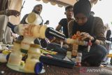 Pengrajin menyelesaikan pembuatan miniatur robot berbahan limbah di Tigaraksa, Kabupaten Tangerang, Banten, Jumat (11/10/2024). Pengrajin Yayasan Oemah Daon memanfaatkan limbah rumah tangga seperti botol kemasan bekas hingga mainan bekas untuk dijadikan miniatur robot yang dijual seharga Rp50 ribu hingga Rp500 ribu tergantung ukuran, sekaligus sebagai sarana edukasi pemanfaatan limbah menjadi karya kepada masyarakat. ANTARA FOTO/Sulthony Hasanuddin/gp