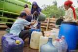 Warga mengisi air ke wadah saat penyaluran bantuan air bersih di Desa Jenggrong, Kecamatan Ranuyoso, Lumajang, Jawa Timur, Selasa (15/10/2024). Pemerintah Kabupaten Lumajang melalui Badan Penanggulangan Bencana Daerah (BPBD) menyalurkan bantuan air bersih sebanyak sembilan armada tangki berkapasitas 5.000 liter ke 213 titik di 18 Desa terdampak kekeringan sejak tiga bulan terakhir. Antara Jatim/Irfan Sumanjaya/um