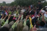 Presiden ketujuh RI Joko Widodo dari atas kendaraan menyapa warga saat melintas di jalan Colomadu, Karanganyar, Jawa Tengah, Minggu (20/10/2024). Joko Widodo resmi purna tugas dari Presiden Indonesia dan kembali pulang ke Solo. ANTARA FOTO/Aloysius Jarot Nugroho/Spt/gp