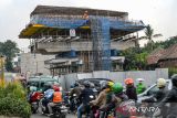 Kendaraan melintas di samping proyek Jalan Layang Nurtanio di Bandung, Jawa Barat, Senin (21/10/2024). Balai Besar Pelaksanaan Jalan Nasional (BBPJN) DKI Jakarta-Jawa Barat, Kementerian PUPR menyatakan proyek pembangunan Jalan Layang Nurtanio sepanjang 550 meter tersebut terkendala pembebasan lahan yang dapat mengakibatkan pengerjaan tidak sesuai dengan target. ANTARA FOTO/Raisan Al Farisi/agr