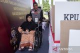 Anggota Kelompok Penyelenggara Pemungutan Suara (KPPS) membantu warga penyandang disabilitas saat simulasi pemungutan dan penghitungan suara pemilihan serentak 2024 di Cisarua, Kabupaten Bandung Barat, Jawa Barat, Sabtu (26/10/2024). Simulasi yang digelar oleh KPU Provinsi Jawa Barat tersebut dilakukan sebagai persiapan bagi para petugas penyelenggara dan warga mengenai tata cara pemungutan dan penghitungan suara Pilkada 2024 yang akan dilaksanakan serentak pada 27 November. ANTARA FOTO/Abdan Syakura/agr