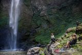 Wisatawan mancanegara berfoto dengan latar belakang Curug Pelangi Cimahi di Cisarua, Kabupaten Bandung Barat, Jawa Barat, Minggu (27/10/2024). Air terjun atau curug yang memiliki ketinggian 87 meter dan menjadi salah satu air terjun tertinggi di Jawa Barat tersebut berpotensi menjadi destinasi wisata unggulan yang dapat meningkatkan kunjungan pariwisata serta perekonomian masyarakat di kawasan tersebut. ANTARA FOTO/Abdan Syakura/agr
