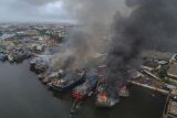 Kebakaran kapal di Pelabuhan Panjang Wetan, Kota Pekalongan. Foto udara petugas pemadam kebakaran berupaya memadamkan api ketika terjadi kebakaran kapal di Panjang Wetan, Kota Pekalongan, Jawa Tengah, Selasa (12/11/2024). Api yang menghanguskan sebanyak 13 kapal tersebut dapat dikendalikan setelah enam unit mobil pemadam kebakaran dikerahkan, penyebab kebakaran masih dalam proses penyelidikan. ANTARA FOTO/Harviyan Perdana Putra/Spt.ANTARA FOTO/Harviyan Perdana Putra (ANTARA FOTO/Harviyan Perdana Putra)