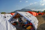 Pengungsi terdampak erupsi Gunung Lewotobi Laki-laki Katarina Kire menggendong anaknya yang baru saja lahir di posko pengungsian Desa Kobasoma, Titehena, Kabupaten Flores Timur, NTT, Rabu (13/11/2024). Di tengah kondisi darurat akibat bencana erupsi Lewotobi mereka merawat putra mereka yang lahir secara normal pada Rabu dini hari. ANTARA FOTO/Aditya Pradana Putra/Spt.