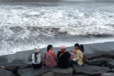 Wisatawan berada di pinggir pantai saat berwisata di Pantai Purnama, Gianyar, Bali, Minggu (1/12/2024). Kantor Perwakilan Bank Indonesia (BI) Provinsi Bali memetakan empat strategi untuk mengejar pertumbuhan ekonomi di Pulau Dewata yang diperkirakan menembus kisaran 5,0-5,8 persen pada 2025 dimana salah satu strategi yang dapat menggenjot ekonomi yakni pariwisata berbasis budaya, kearifan lokal, promosi desa wisata dan umkm penunjang pariwisata serta digitalisasi sektor pariwisata. ANTARA FOTO/Nyoman Hendra Wibowo/wsj.