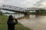 Warga melihat kondisi jembatan rusak di Kertosono, Nganjuk, Jawa Timur, Selasa (3/12/2024). Jembatan peninggalan Belanda yang menjadi alternatif penghubung tiga kabupaten yakni Kabupaten Nganjuk, Kabupaten Jombang, serta Kabupaten Kediri itu kini kondisinya rusak berat dan telah ditutup total sejak tahun 2018. ANTARA Jatim/Muhammad Mada/mas.