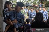 Prajurit TNI AU Lanud Husein Sastranegara menggendong seorang anak penyintas bencana tanah bergerak saat memberikan layanan trauma healing di Kadupandak, Kabupaten Cianjur, Jawa Barat, Sabtu (7/12/2024). Layanan terapi trauma healing tersebut guna memulihkan dampak psikologis serta meningkatkan semangat bagi anak-anak penyintas akibat bencana geologi tanah bergerak. ANTARA FOTO/Novrian Arbi/agr