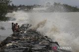 Sejumlah anak bermain di bibir pantai saat gelombang tinggi menerjang di Desa Jongor, Kecamatan Sidamukti, Kabupaten Pandeglang, Banten, Sabtu (14/12/2024). Badan Meteorologi, Klimatologi dan Geofisika (BMKG) mengeluarkan peringatan dini potensi gelombang tinggi di wilayah perairan Banten dengan kisaran 1,25 hingga 2,50 meter yang diperkirakan terjadi di Selat Sunda bagian utara, sedangkan gelombang tinggi dengan ketinggian 2,50 meter hingga empat meter diperkirakan terjadi di Selat Sunda bagian barat, perairan selatan Pandeglang, dan perairan selatan Lebak. ANTARA FOTO/Angga Budhiyanto/gp