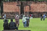 Sejumlah wisatawan mengunjungi Candi Gumpung dalam Kawasan Cagar Budaya Nasional (KCBN) Muarajambi di Muaro Jambi, Jambi, Kamis (26/12/2024). Kawasan situs cagar budaya yang diperkirakan dibangun pada abad ke-6 dan menjadi kawasan pendidikan Buddha terbesar di Asia Tenggara atau seluas 3.981 hektare itu menjadi pilihan sebagian warga untuk memanfaatkan waktu libur Natal 2024 dan Tahun Baru 2025 dengan kunjungan rata-rata per hari 500 orang lebih. ANTARA FOTO/Wahdi Septiawan/YU