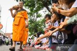 Sejumlah warga menyambut sejumlah Biksu Thudong dalam rangkaian Pabajja Samanera di Kota Tangerang, Banten, Minggu (29/12/2024). Sejumlah Biksu Thudong berjalan bersama peserta Samanera dari Perguruan Budhi Dharma Tangerang menuju Vihara Boen Tek Bio untuk melakukan prosesi Pindapata. ANTARA FOTO/Sulthony Hasanuddin/gp