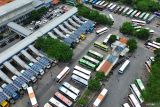 Foto Udara sejumlah armada bus parkir di Terminal Purabaya, Bungurasih, Sidoarjo, Jawa Timur, Selasa (31/12/2024). Berdasarkan data terminal Purabaya Bungurasih, jumlah penumpang bus pada libur Natal dan Tahun Baru 2025 mencapai sekitar 45.000-50.000 orang atau naik dari hari biasa dengan jumlah penumpang sekitar 11.136-19.301 orang dengan 2500 armada bus Antar Kota Dalam Provinsi (AKDP) dan Antar Kota Antar Provinsi (AKAP). Antara Jatim/Umarul Faruq