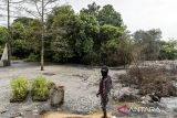 Warga melihat lahan yang terendam limbah bahan berbahaya dan beracun (B3) di Desa Sukamaju, Kibin, Kabupaten Serang, Banten, Jumat (3/1/2025). Menurut keterangan warga, limbah B3 tersebut mengakibatkan lingkungan tercemar, tempat pemakaman umum terendam, tanah dan air berubah warna menjadi hitam dan menimbulkan bau menyengat serta tanaman dan ikan di lingkungan sekitar mati. ANTARA FOTO/Putra M. Akbar/gp