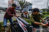 Warga membantu pengendara yang motornya mogok akibat menerjang banjir di Jalan Lingkar Selatan, Kota Cilegon, Banten, Kamis (9/1/2025). BPBD Kota Cilegon mencatat sebanyak enam titik lokasi banjir hingga jalan menuju kawasan wisata Anyer terendam banjir dengan ketinggian air mencapai 50 sentimeter hingga 1 meter akibat hujan lebat yang terjadi sejak semalam sehingga membuat warga kesulitan beraktivitas. ANTARA FOTO/Muhammad Bagus Khoirunas/gp