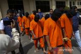Polisi menggiring para tersangka untuk dihadirkan dalam pengungkapan kasus tindak pidana pertambangan emas tanpa izin (PETI) di Polda Banten, Kota Serang, Banten, Jumat (7/2/2025). Polda Banten berhasil mengamankan sebanyak 10 tersangka yang melakukan penambangan sekaligus pengolahan emas ilegal di wilayah Kabupaten Lebak dengan barang bukti berupa mesin gelondong, batuan mengandung mineral emas, kowi, tabung gas, palu martil, lingkar, merkuri, dan dinamo dengan ancaman pidana penjara paling lama lima tahun dan denda paling banyak Rp100 miliar. ANTARA FOTO/Angga Budhiyanto/gp