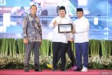 Menteri Sosial Saifullah Yusuf (tengah) menerima piagam dari Ketua Forum Rektor Indonesia (FRI) Nurhasan (kanan) disaksikan Wakil Menteri Pendidikan Tinggi, Sains, dan Teknologi Fauzan (kiri) saat penandatangan nota kesepahaman (MoU) antara Kemensos dan FRI di Graha Unesa, Surabaya, Jawa Timur, Senin (10/2/2025). Nota kesepahaman tersebut terkait kerja sama untuk mengentaskan masalah kemiskinan di wilayah Jawa Timur. Antara Jatim/Rizal Hanafi/um