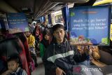 Pemudik memegang poster saat pelepasan Mudik Gratis di Polres Cimahi, Jawa Barat, Kamis (27/3/2025). Polres Cimahi memberangkatkan 160 pemudik dengan menggunakan tiga bus ke daerah tujuan Semarang, Jawa Tengah secara gratis. ANTARA FOTO/Abdan Syakura/agr
