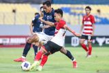 Pesepak bola Madura United Irfan (kanan) menendang bola dengan dibayangi pesepak bola Svay Rieng Saret Krya (kiri) pada leg kedua semifinal AFC Challenge League di Stadion Gelora Joko Samudro, Gresik, Jawa Timur, Kamis (17/4/2025). Madura United bermain imbang melawan Svay Rieng dengan skor 3-3 dan gagal melaju ke babak final AFC Challenge League usai kalah agregat dengan skor 3-6. Antara Jatim/Rizal Hanafi/um