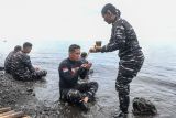 Prajurit TNI AL melakukan prosesi adat dan doa sebelum penurunan prasasti tugu beton ke dasar laut pada persiapan pemasangan Prasasti Kapal USS Liberty yang tenggelam di perairan Laut Tulamben, Desa Tulamben, Kubu, Bali, Rabu (16/4/2025). Acara yang dilaksanakan Dinas Sejarah TNI AL bersama Kedutaan Besar Amerika tersebut akan digelar pada Kamis (17/4). ANTARA FOTO/Muhammad Adimaja/wsj.
