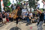 Massa yang tergabung dalam Gerakan Rakyat Selamatkan Bumi menampilkan kesenian reak saat aksi di Gedung Sate, Jalan Diponegoro, Bandung, Jawa Barat, Selasa (22/4/2025). Aksi yang diselenggarakan dalam rangka Hari Bumi tersebut menuntut Pemerintah Provinsi Jawa Barat untuk mengevaluasi KSO seluruh tambang yang ada di Jawa Barat, realisasi kawasan Puncak Bogor-Cianjur sebagai nuansa etis bagi turis lokal serta berbagai permasalahan lingkungan yang belum terselesaikan di Jawa Barat. ANTARA FOTO/Raisan Al Farisi/agr