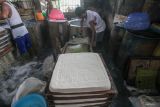 Pekerja menyelesaikan proses pembuatan tahu di Ketegan Barat, Taman, Sidoarjo, Jawa Timur, Rabu (23/4/2025). Produsen tahu setempat mengeluhkan harga kedelai impor yang sudah naik sejak sepekan terakhir dari Rp7.500 hingga Rp8.000 per kilogram menjadi Rp10.000 per kilogram yang berdampak terhadap meningkatnya biaya produksi tahu dan omzet mereka. Antara Jatim/Umarul Faruq