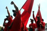 Buruh membawa bendera saat mengikuti aksi Hari Buruh Internasional di depan Gedung DPRD, Malang, Jawa Timur, Kamis (1/5/2025). Unjuk rasa gabungan dari Solidaritas Perjuangan Buruh Indonesia (SPBI) dan berbagai elemen mahasiswa tersebut menuntut pemerintah memperjuangkan kesejahteraan buruh dengan membuka lapangan kerja baru serta mencegah Pemutusan Hubungan Kerja (PHK) sepihak. ANTARA Jatim/Ari Bowo Sucipto/mas.